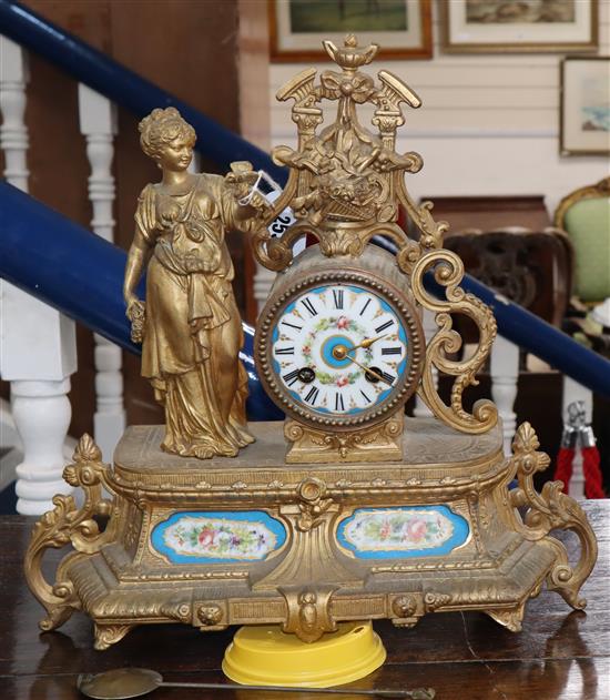 A Louis XV style gilt metal cased 8 day mantel clock, with Sevres style porcelain mounts